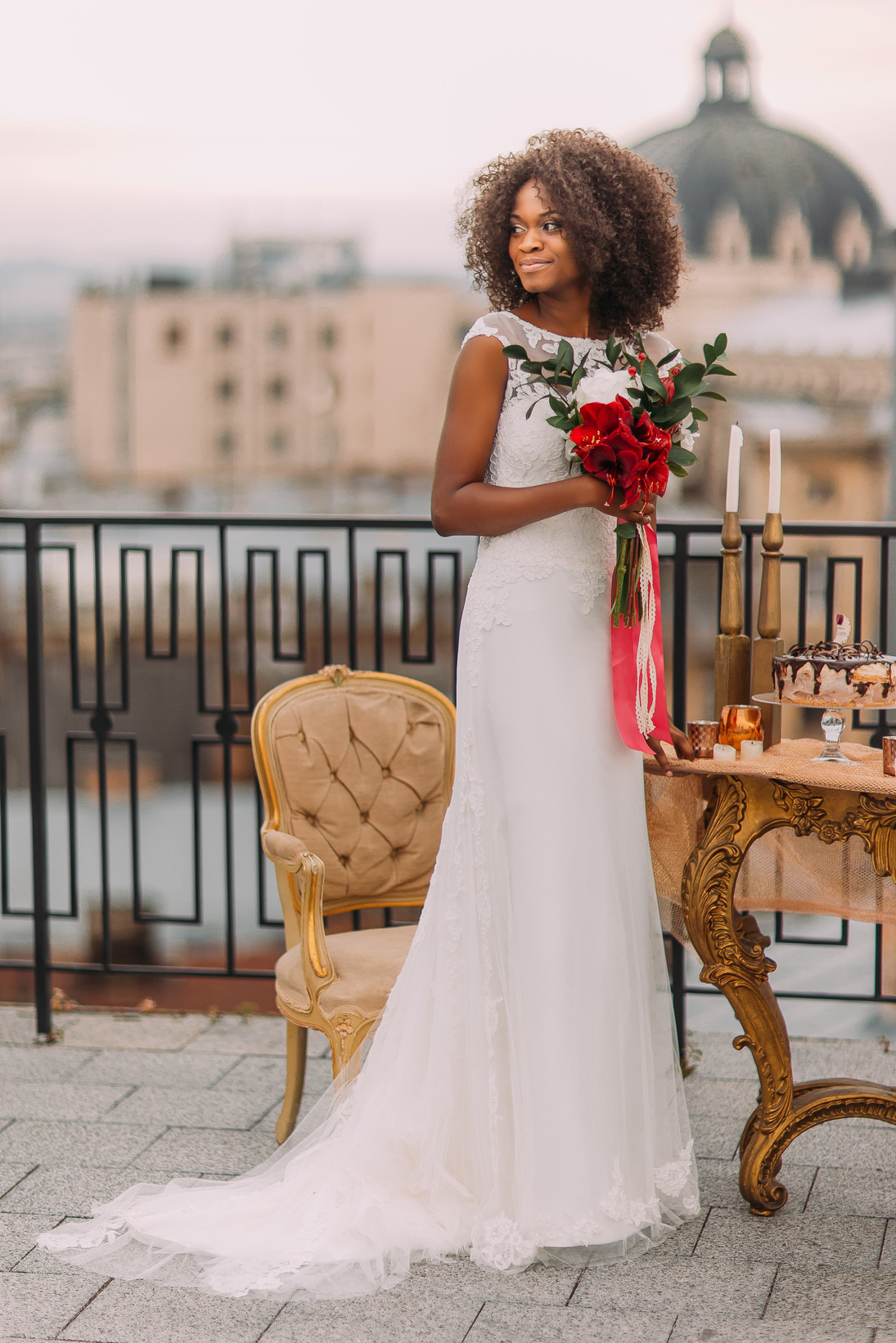 Charming black bride with wedding bouquet in hands standing on